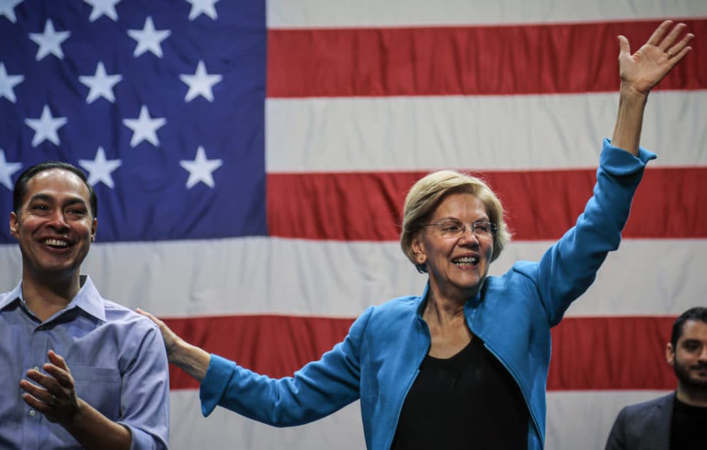 Democratic presidential candidate Sen. Elizabeth Warren, D-Mass., right, joined by former Secretary of Housing and Urban Development and presidential candidate Julian Castro, left, wave to supporters after speaking at a campaign rally, Tuesday, Jan. 7, 2020, at Brooklyn's King Theatre in New York. (AP Photo/Bebeto Matthews)