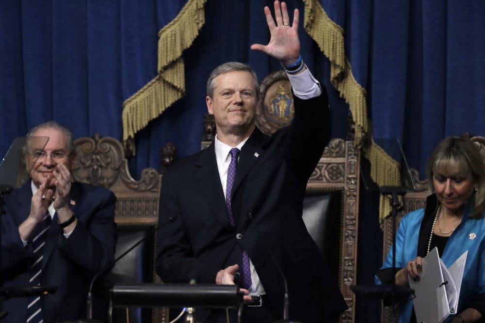 Massachusetts Gov. Charlie Baker, center, waves at the conclusion of his state of the state address in the House Chamber as Speaker of the House Robert DeLeo, behind left, and Senate President Karen Spilka, right, look on, Tuesday, Jan. 21, 2020, at the Statehouse, in Boston. (Steven Senne/AP)