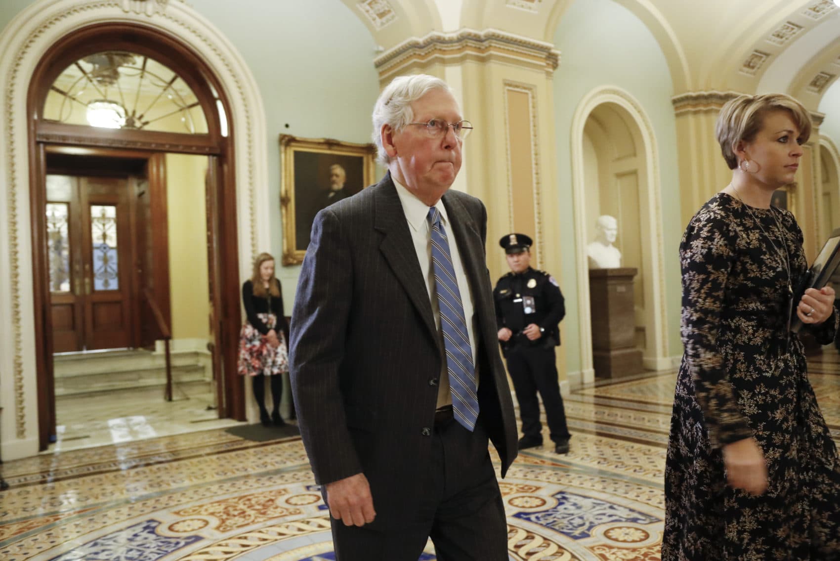 Senate Majority Leader Mitch McConnell walks outside the Senate chamber at the Capitol in Washington during a break in the impeachment trial of President Donald Trump on Jan. 24, 2020. (Julio Cortez/AP)