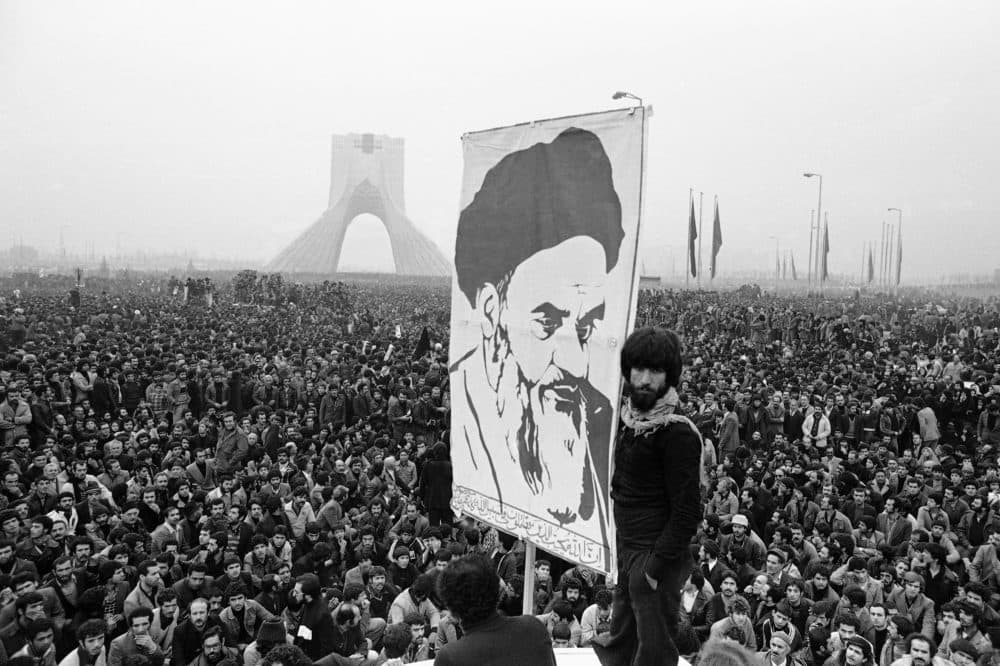 Picture of exiled Muslim leader Ayatollah Khomeini overshadows huge anti-Shah demonstration commemorating 25 years of the monarch's rule and symbol of his power, Dec. 10, 1978, in Tehran. (Michel Lipchitz/AP)