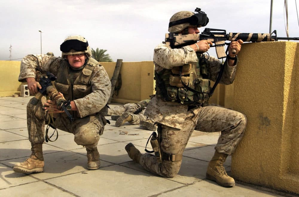 In this Sunday, Oct. 31, 2004 file photo, U.S. Marine snipers from the 2nd Battalion, 5th Marine Regiment, take cover during a gun battle with insurgents in Ramadi in Anbar province, Iraq. (Jim MacMillan/AP)
