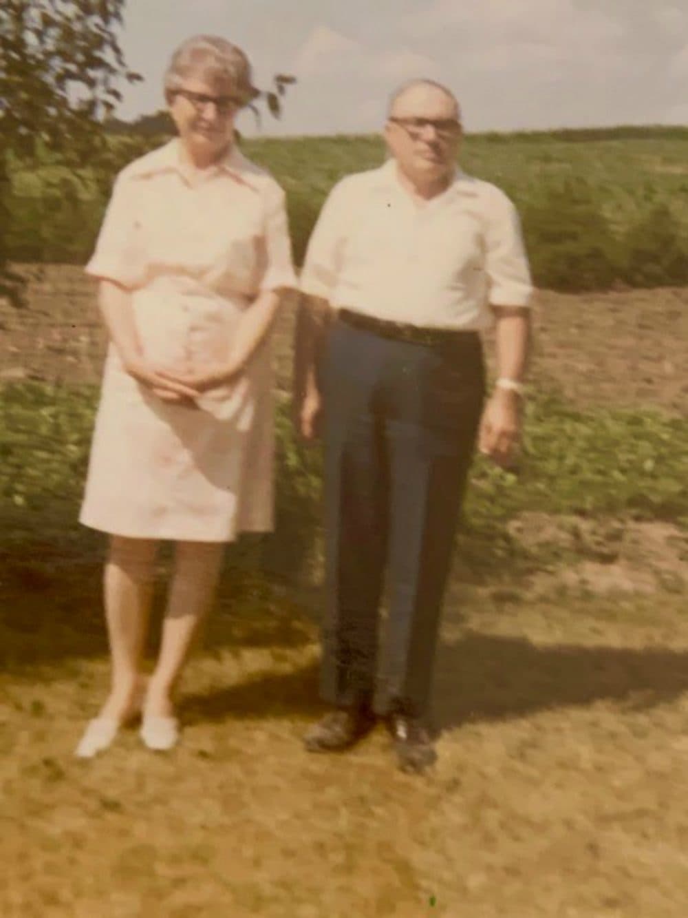 The author's parents, standing in front of her father’s garden, Ida Grove, Iowa. (Courtesy)