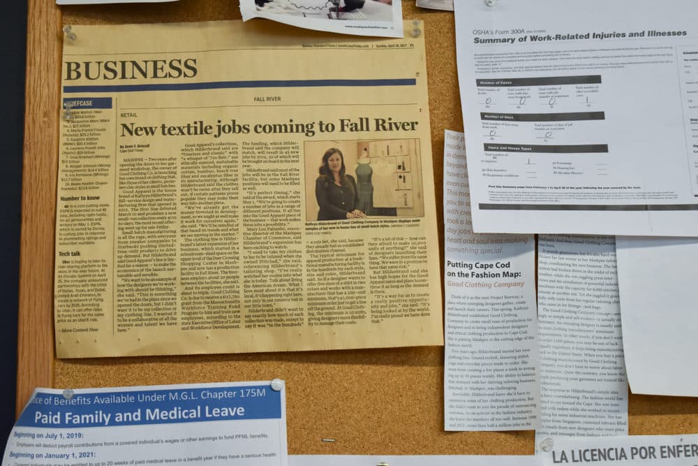 A newspaper clipping about the opening of Good Clothing Company hangs on the wall at the Fall River factory. (Allison Hagan/Here &amp; Now)