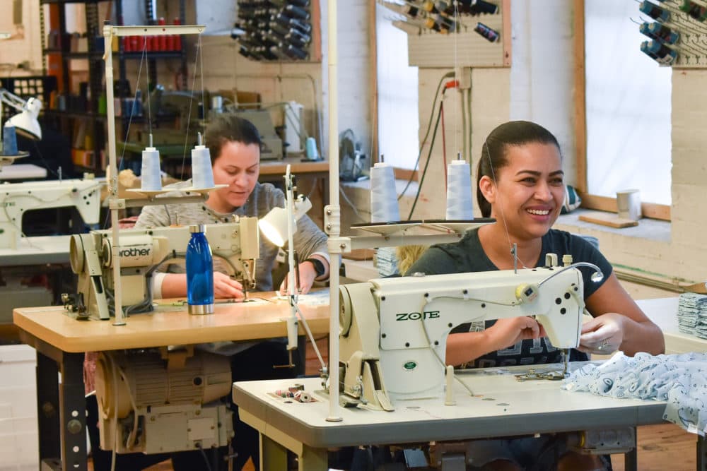 Seamstress working industrial sewing machines at Good Clothing Company in Fall River, Massachusetts. (Allison Hagan/Here &amp; Now)