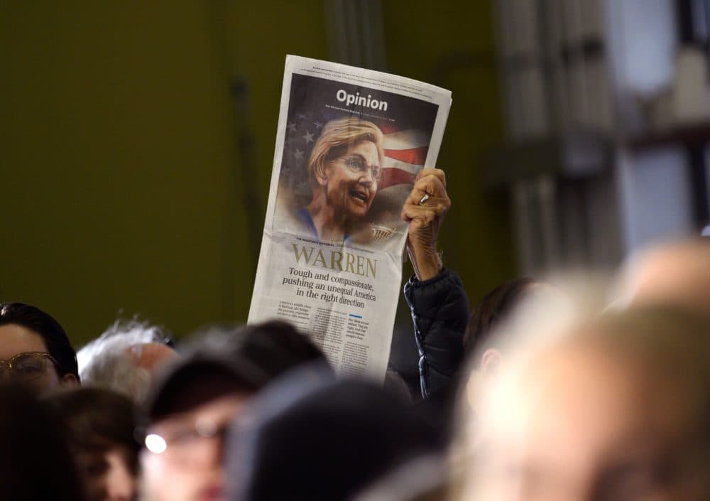 An event attendee holds up a copy of the Des Moines Register newspaper's Opinion page endorsement of Democratic presidential candidate Elizabeth Warren during a campaign stop in Cedar Rapids, Iowa on Jan. 26, 2020. (Photo by Stephen Maturen /AFP via Getty Images)