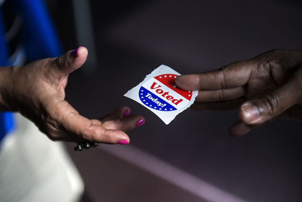 A poll worker hands out &quot;I Voted Today&quot; stickers. (Brendan Smialowski/AFP/Getty Images)