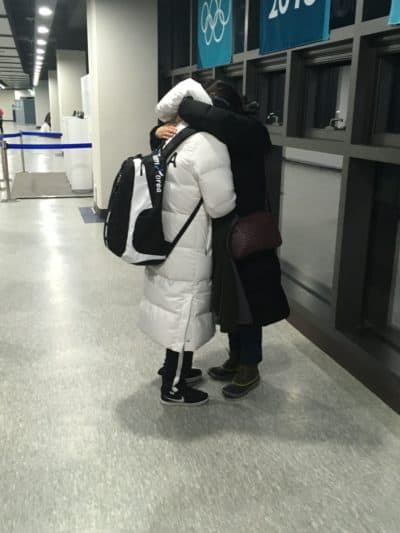 Grace Lee hugs her mother, Eliza, after Korea's devastating 8-0 loss to Sweden. (Courtesy Seth Berkman) 