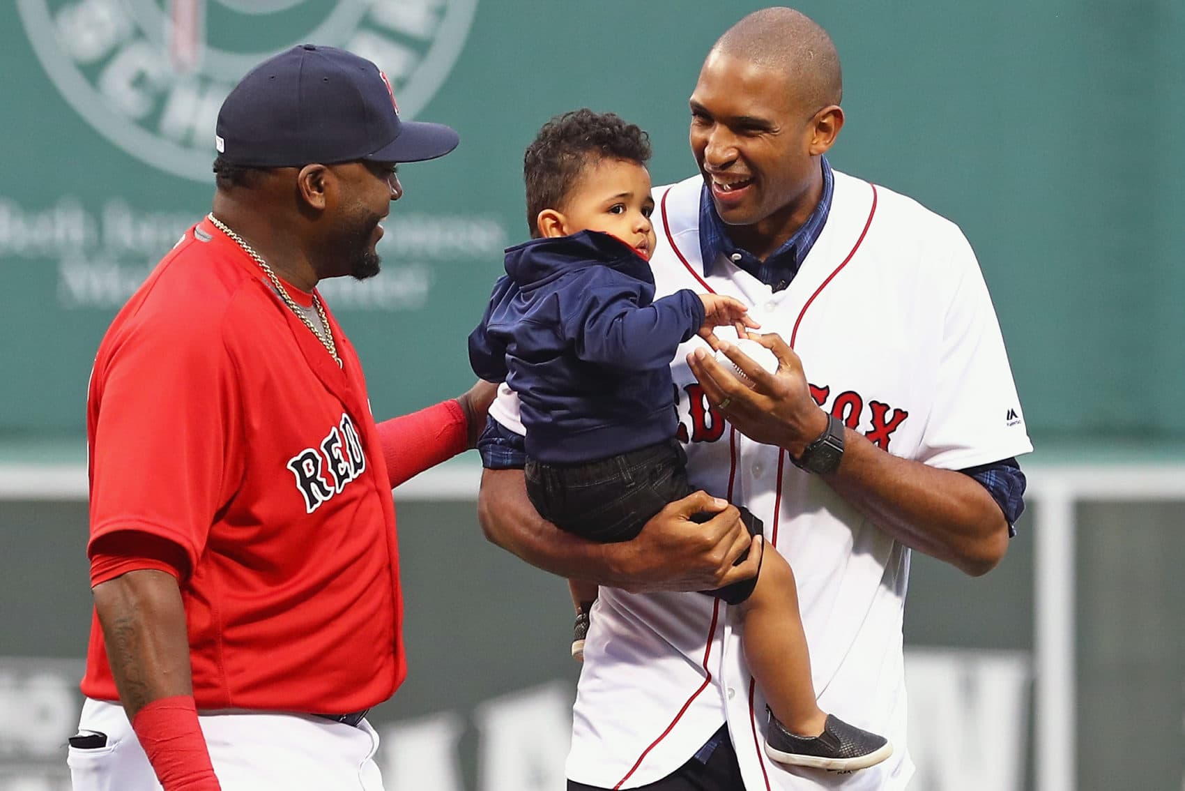 Newly signed Boston Celtic Al Horford, holding his son Ean, talks with David Ortiz after throwing out the first pitch before a game at Fenway Park in July 2016. (Maddie Meyer/Getty Images)
