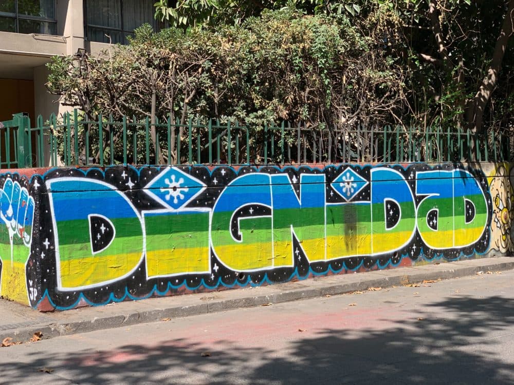 Grafitti on a wall in Santiago. (Amelia Mason/WBUR)