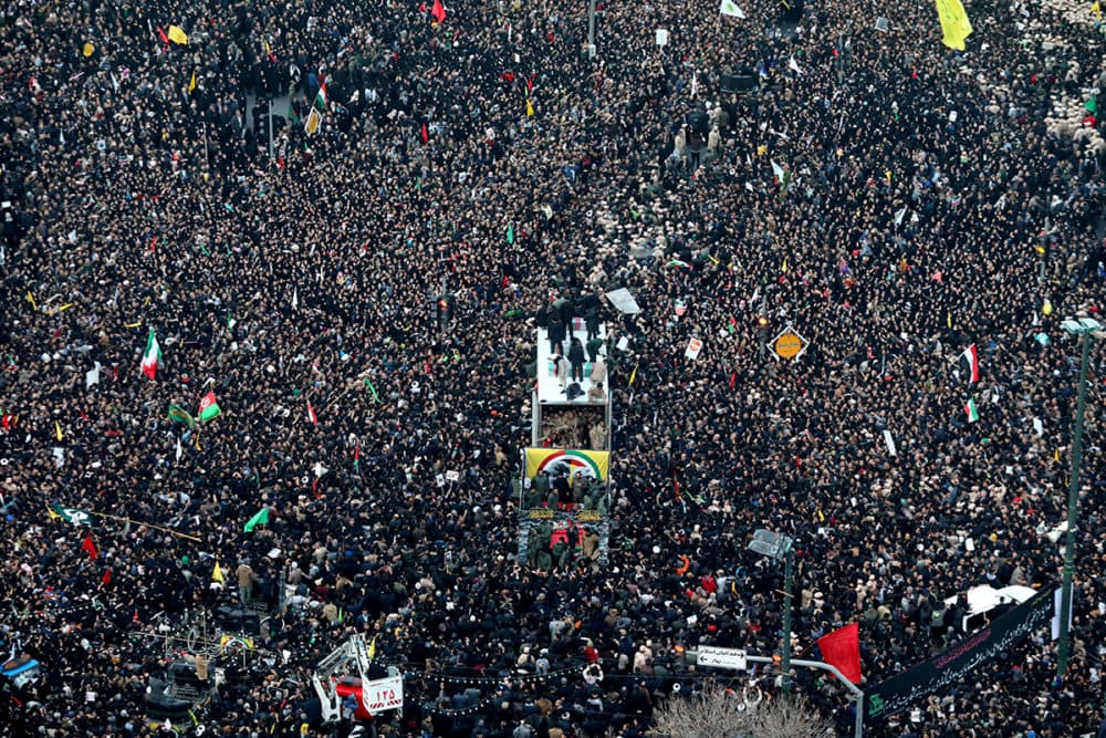 Coffins of Gen. Qassem Soleimani and his comrades who were killed in Iraq by a U.S. drone strike, are carried on a truck surrounded by mourners during a funeral procession, in the city of Mashhad, Iran, Sunday, Jan. 5, 2020. (Mohammad Hossein Thaghi/Tasnim News Agency via AP)