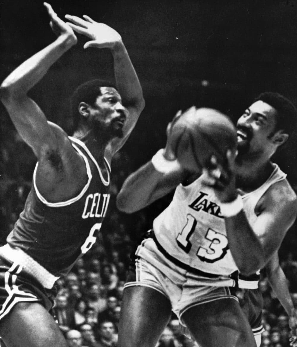 The Los Angeles Lakers' Wilt Chamberlain tries to shoot over Russell during a 1959 playoff game in L.A., but is blocked. (Associated Press)