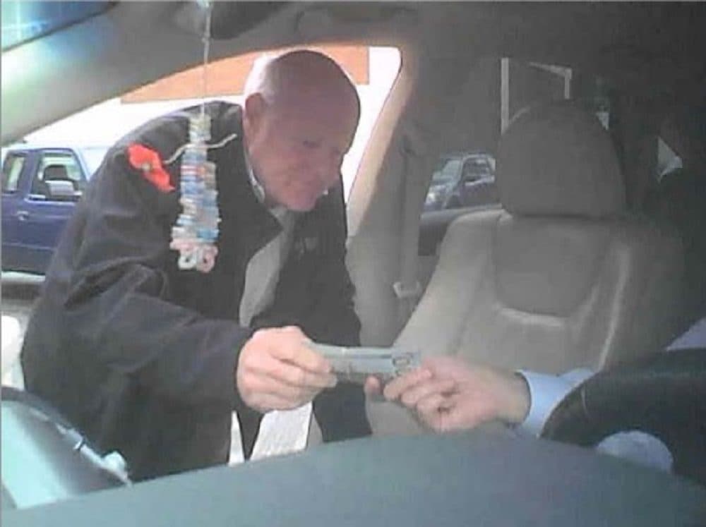 Prosecutors say this October 2018 photo shows former Boston official John Lynch taking a bribe. (Office of the U.S. attorney for Massachusetts)