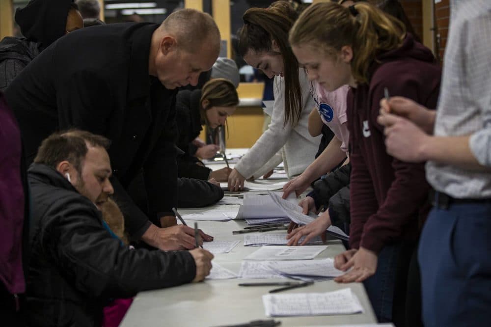 Caucus participants register before entering the auditorium at Central Campus High School in Des Moines, Iowa. (Jesse Costa/WBUR)
