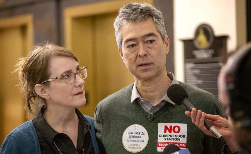 Nathan Phillips, a Boston University earth and anvironment professor, and activist Andrea Honore speak with reporters at the Massachusetts State House. (Robin Lubbock/WBUR)