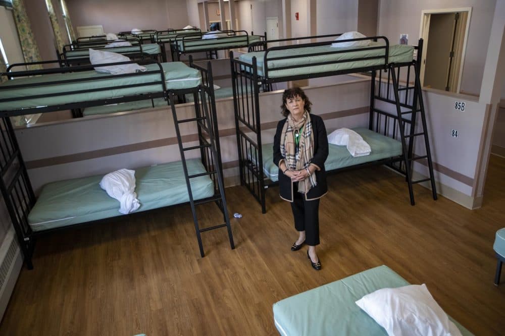 Lyndia Downie, of Pine Street Inn, stands in the women’s shelter dormitory. (Jesse Costa/WBUR)