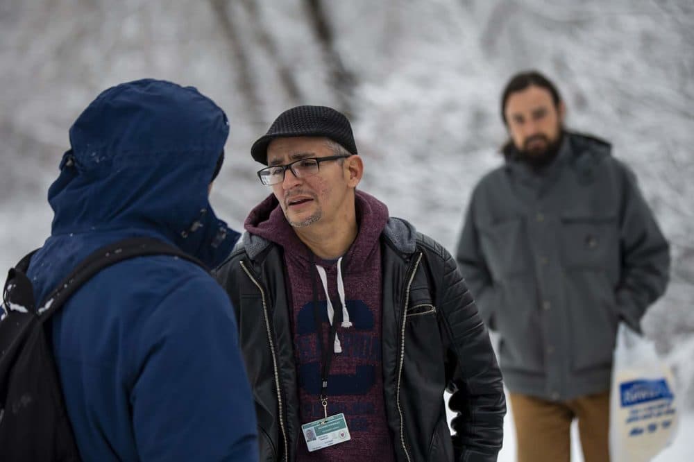 City of Worcester recovery coach Richard Gonzalez asks a Eduardo Vasquez whether he would be willing to stay at a shelter for the night. (Jesse Costa/WBUR)