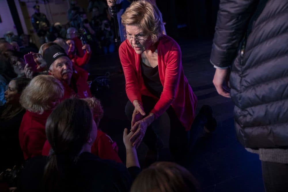 Warren greets supporters in the front row following her speech at Tupelo Music Hall in Derry, N.H. (Jesse Costa/WBUR)