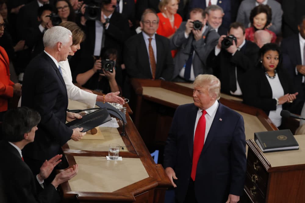 President Trump turns after handing copies of his speech to House Speaker Nancy Pelosi of Calif., and Vice President Mike Pence as he delivers his State of the Union address Tuesday. (J. Scott Applewhite/AP)