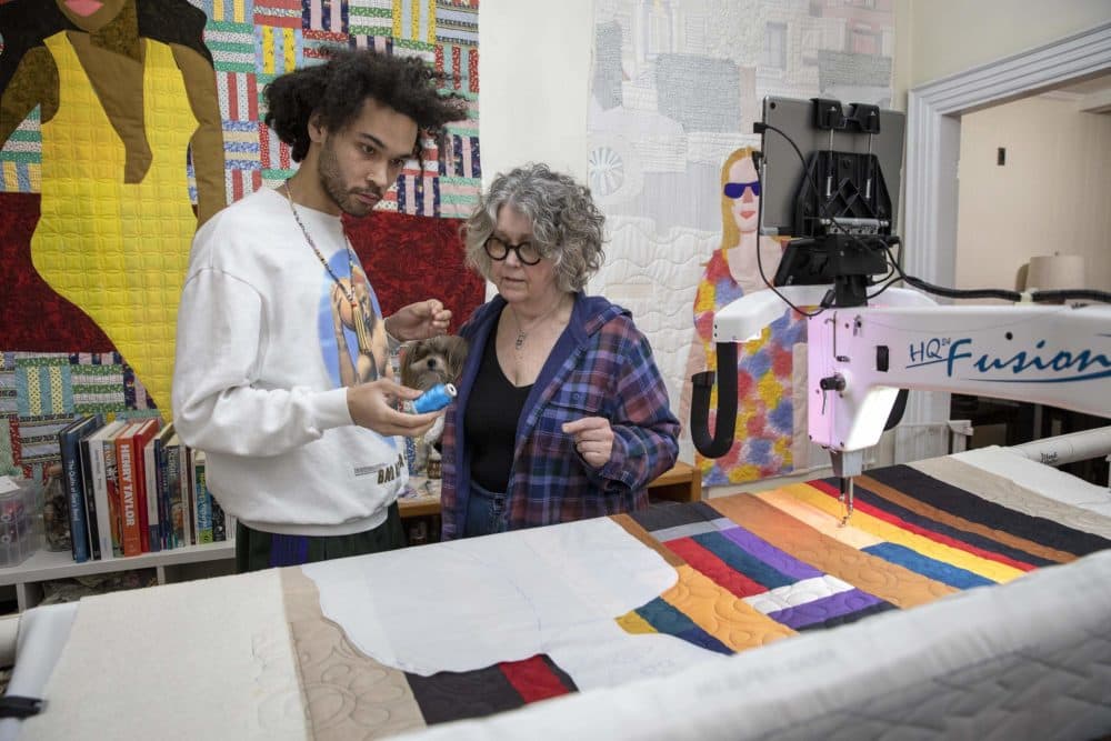 Quilt artist Michael Thorpe and his mother Susan Richards talk about thread colors for one of his quilts. (Robin Lubbock/WBUR)
