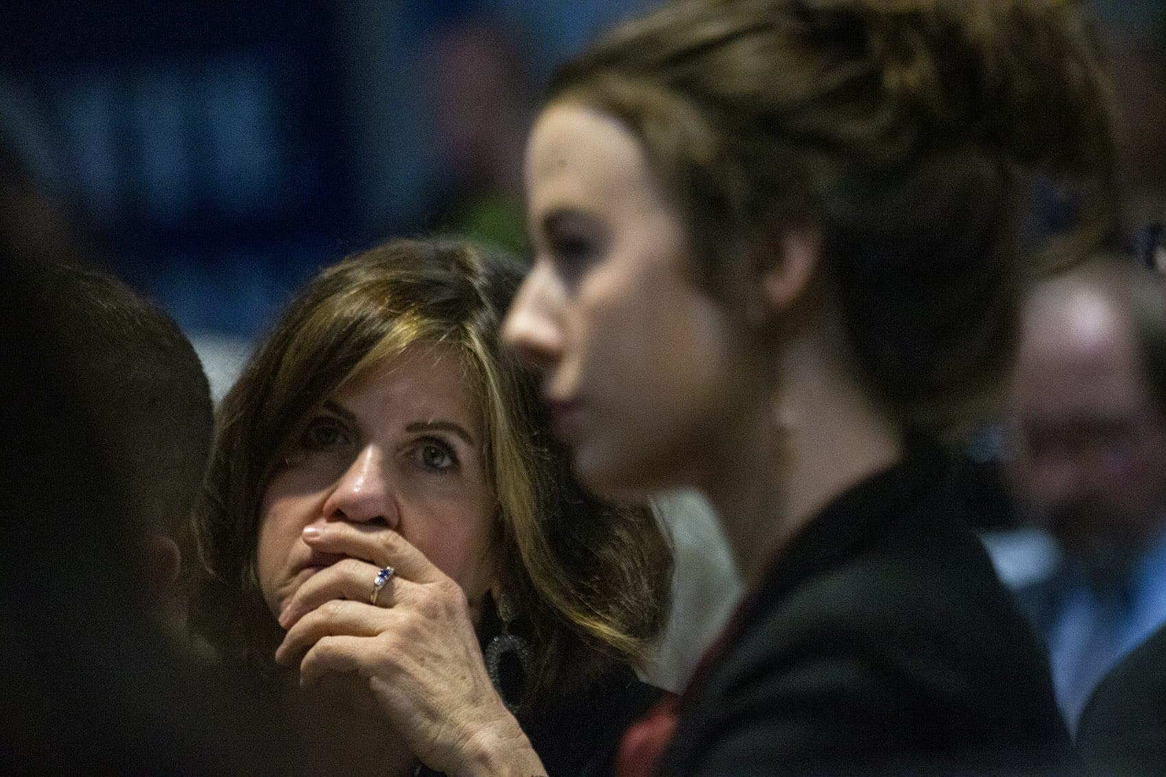 A woman listens intently to presidential candidate Bernie Sanders during a speech given at St. Anselm College in Manchester, NH on February 7, 2020. (Jesse Costa/WBUR)