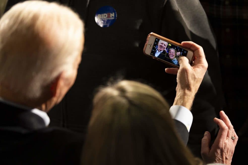 Presidential candidate Joe Biden takes a selfie with a supporter at a campaign rally at the Rex Theater in Manchester, NH. (Jesse Costa/WBUR)
