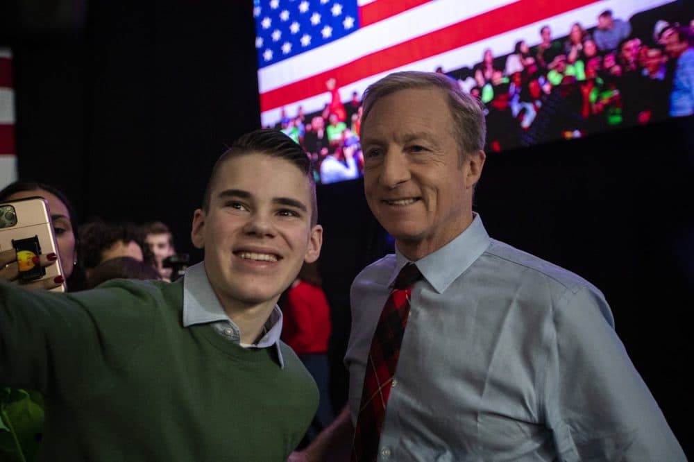 Presidential candidate Tom Steyer takes a selfie with an audience member at the Our Rights, Our Courts Presidential Forum at the New Hampshire Technical Institute in Manchester, NH. (Jesse Costa/WBUR)