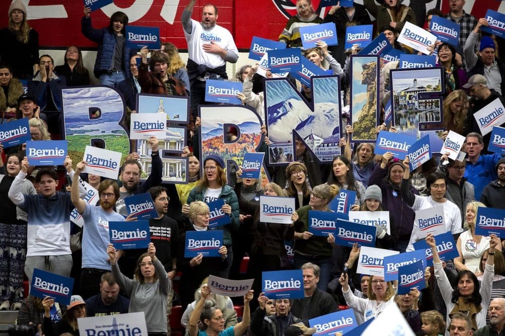 Sanders supporters in Nashua, N.H., wave “Bernie” signs. (Robin Lubbock/WBUR)