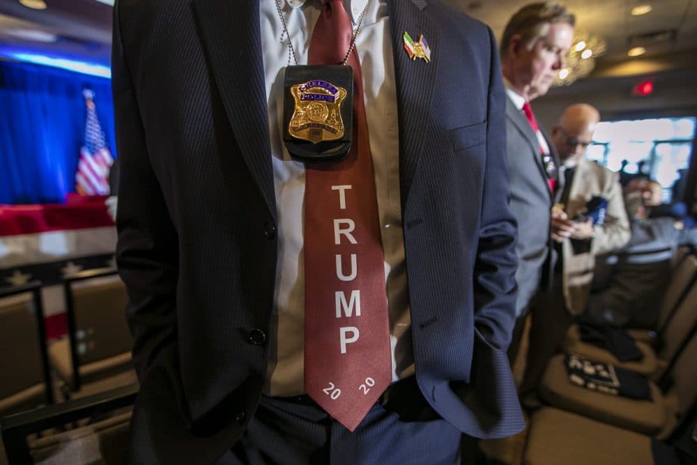 Police officer Joe Bevere wears a Trump campaign tie at the &quot;Cops For Trump&quot; event with Vice President Mike Pence in Portsmouth, N.H. (Jesse Costa/WBUR)