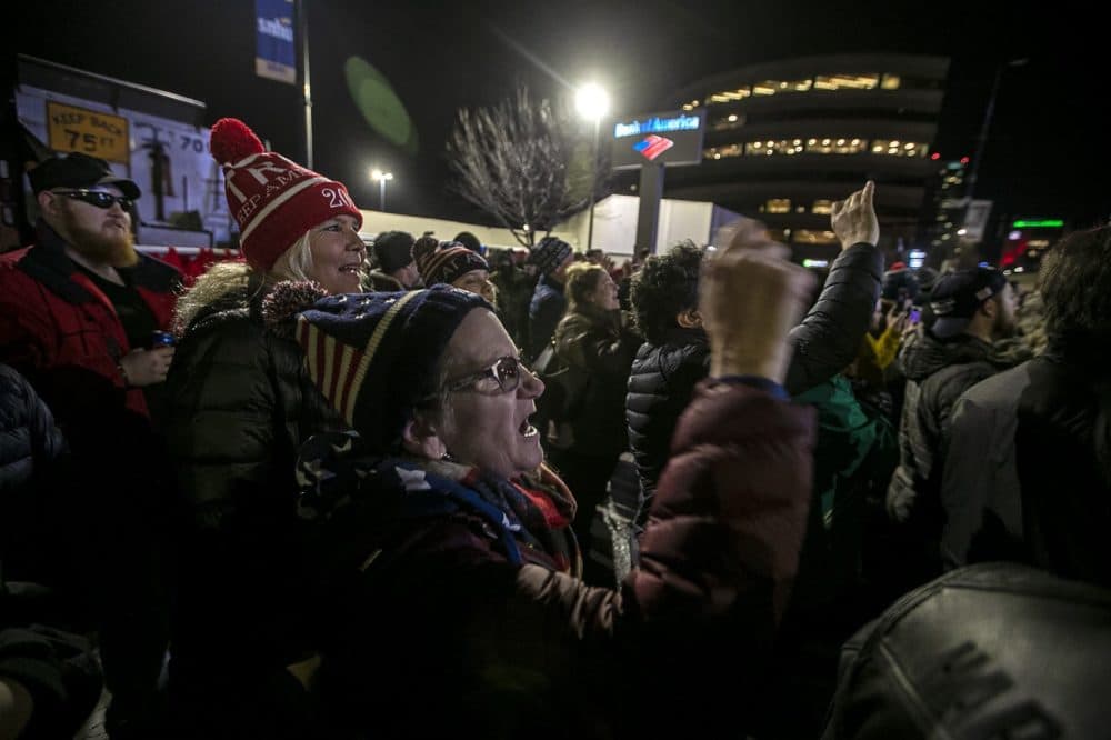 President Donald Trump supporters outside the Southern New Hampshire University Arena cheer as he takes the podium. (Jesse Costa/WBUR)