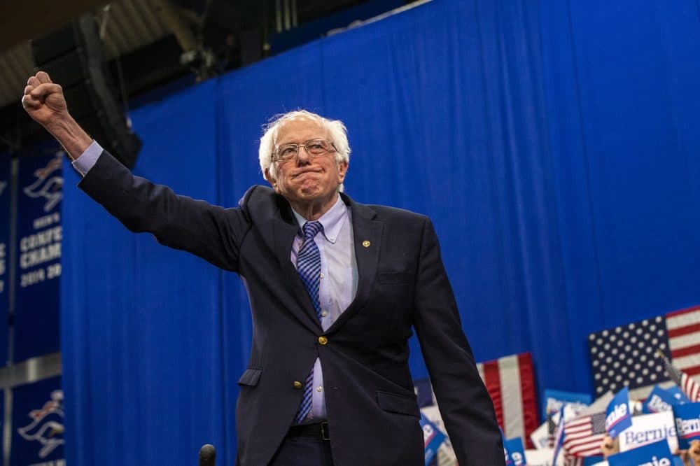 Presidential candidate Bernie Sanders raises his fist in victory to supporters during the New Hampshire primary. (Jesse Costa/WBUR)