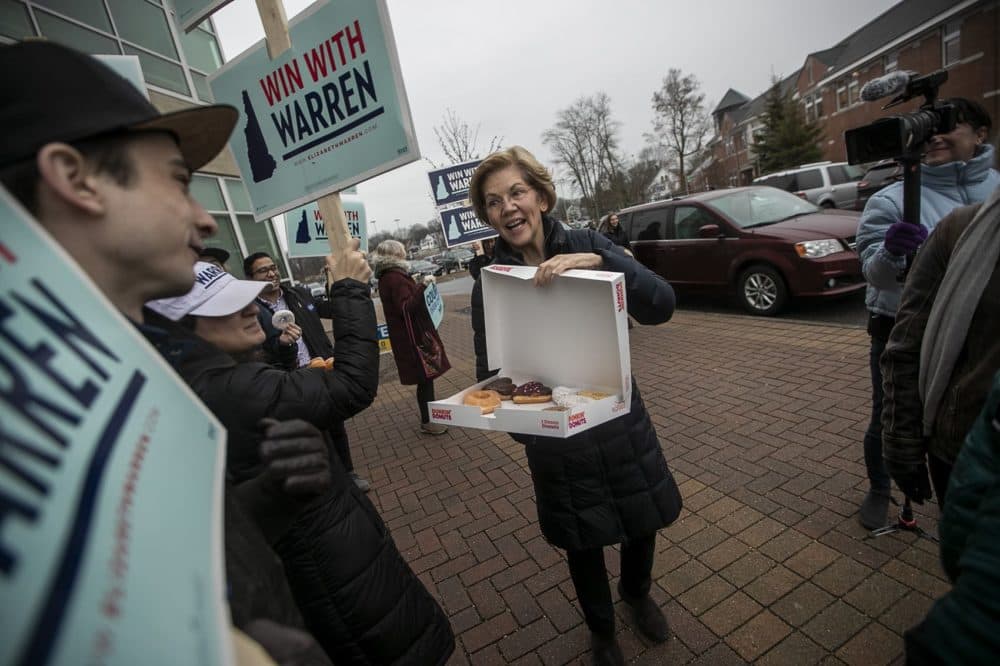 Presidential candidate Elizabeth Warren brings donuts to supporters at a polling place at Portsmouth Middle School as she makes her way across the state one last time for the N.H. Primary. (Jesse Costa/WBUR)