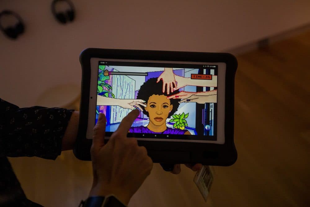 Game designer Momo Pixel developed the old-styled pixelated video game called &quot;Hair Nah,&quot; about a black woman who is tired people trying to touch her hair while they travel. (Jesse Costa/WBUR)