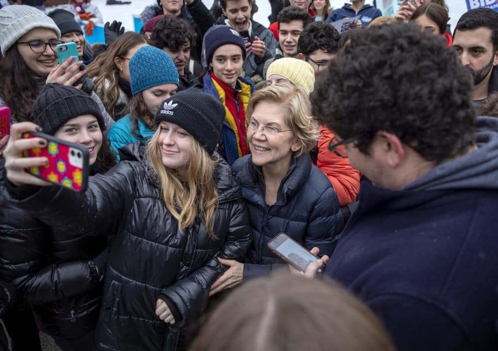 Elizabeth Warren takes a selfie after meeting a large crowd of supporters outside the Webster School in Manchester, N.H. (Robin Lubbock/WBUR)