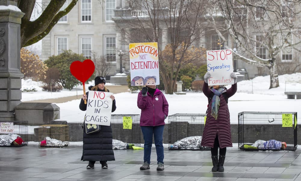 From left to right, Melissa Hinebauch, of Concord, N.H., Deborah Jakubowski, of Loudon, New Hampshire, and Doreen Baker, of Pembroke New Hampshire, take advantage of the increased media presence for the New Hampshire primary, protest U.S. border separations in front of the New Hampshire State House in Concord. (Joe Difazio for WBUR)