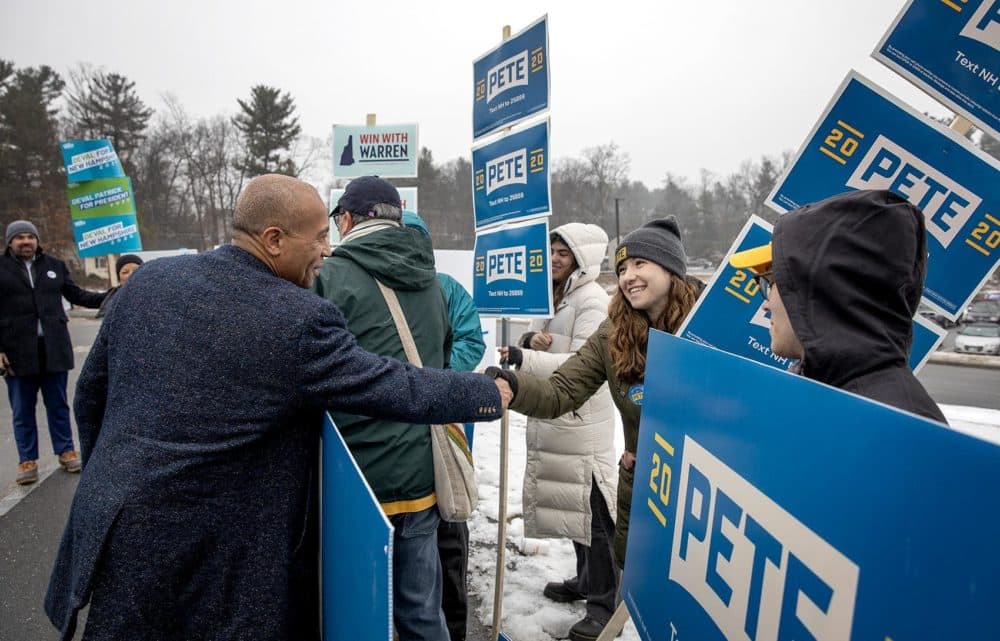 Deval Patrick greets a Buttigieg campaigner outside a polling station in Nashua, NH. (Robin Lubbock/WBUR)
