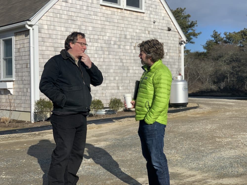 Mark Avery, left, a project manager with the residential construction firm Thirty Acre Wood, catches up with Nantucket's housing chief Tucker Holland. (Simón Rios/WBUR)