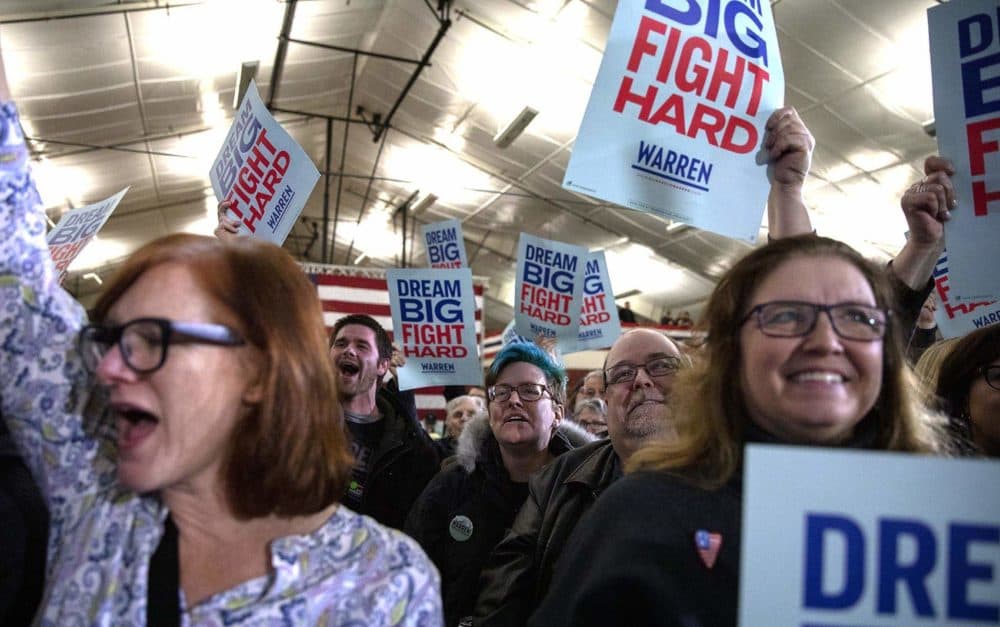 Warren supporters wave “Dream Big Fight Hard” banners at her rally on primary night in Manchester, N.H. (Robin Lubbock/WBUR)