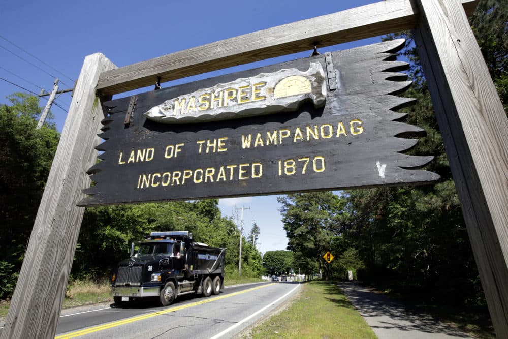 A wooden sign advises motorists of the location of Mashpee Wampanoag tribal lands in Massachusetts. (Steven Senne/AP)
