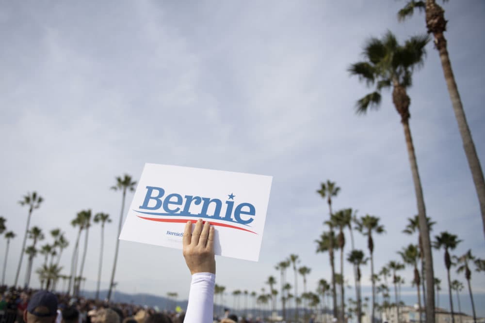 In this Dec. 21, 2019, file photo, a supporter holds up a sign for Democratic presidential candidate Sen. Bernie Sanders, I-Vt., during a rally in Venice, Calif. (Kelvin Kuo/AP)