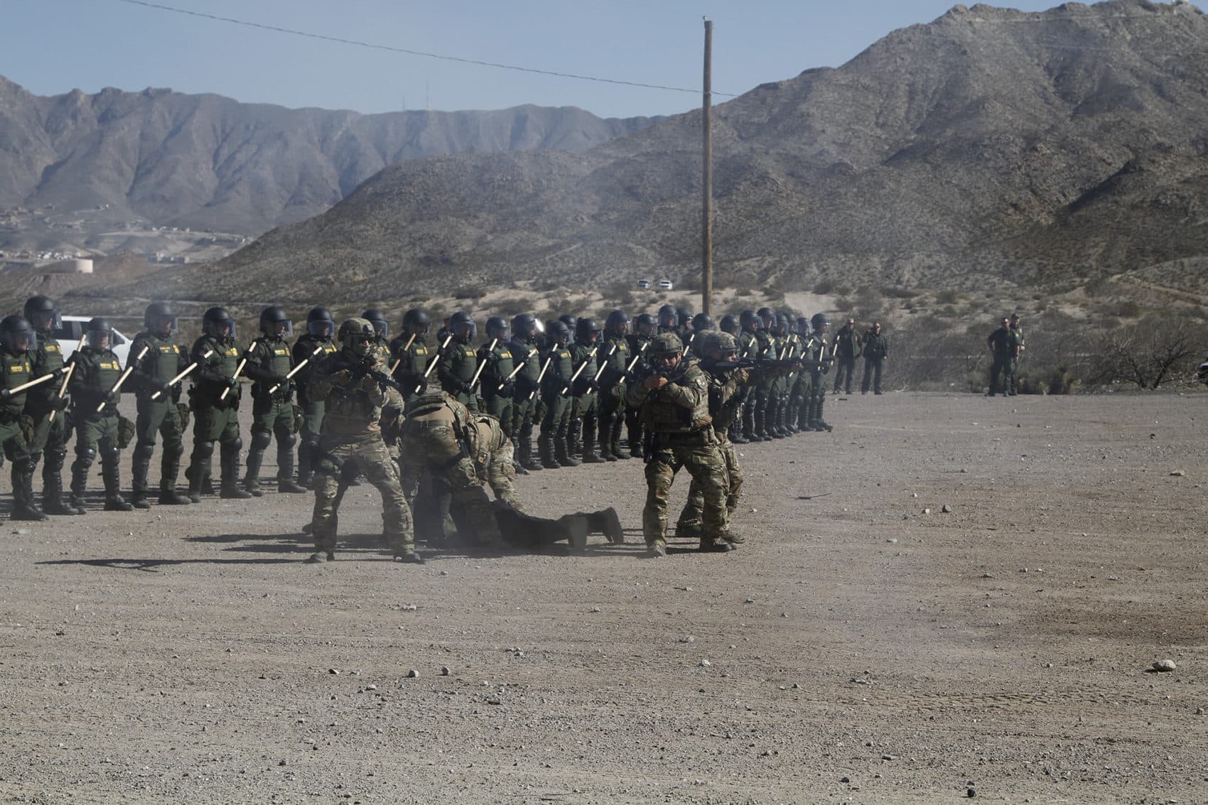 Members of a Customs and Border Protection tactical unit drag away a fellow agent pretending to be an injured protester during a January training exercise in New Mexico. The agency has sent officers and agents trained in SWAT-like tactics to Boston. (Cedar Attanasio/AP)