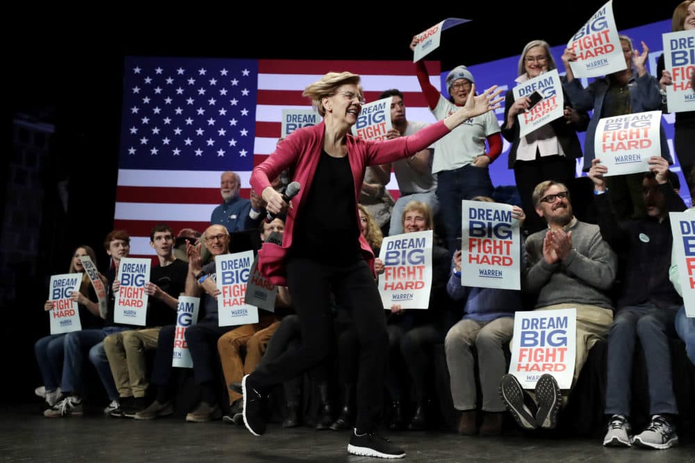 Democratic presidential candidate Sen. Elizabeth Warren, D-Mass., runs on stage as she greets a supporter, not shown, at the start of a campaign stop, in Keene, N.H., Tuesday. (Steven Senne/AP)
