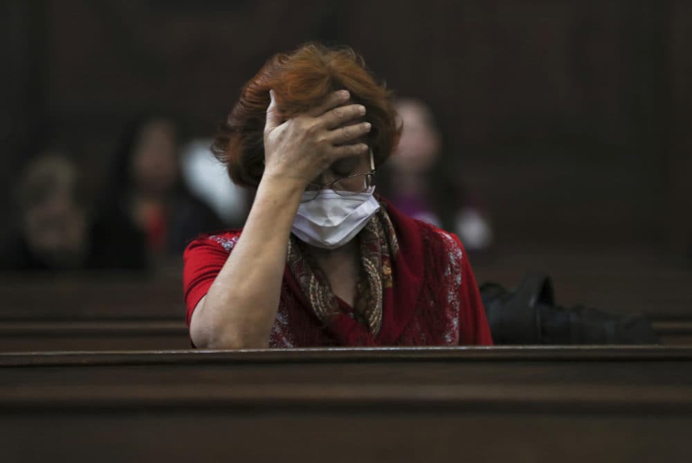 A woman wears a surgical mask as a precaution against the spread of COVID-19 during a Mass commemorating Ash Wednesday at the Cathedral in Mexico City, Wednesday, Feb. 26, 2020. (Fernando Llano/AP)