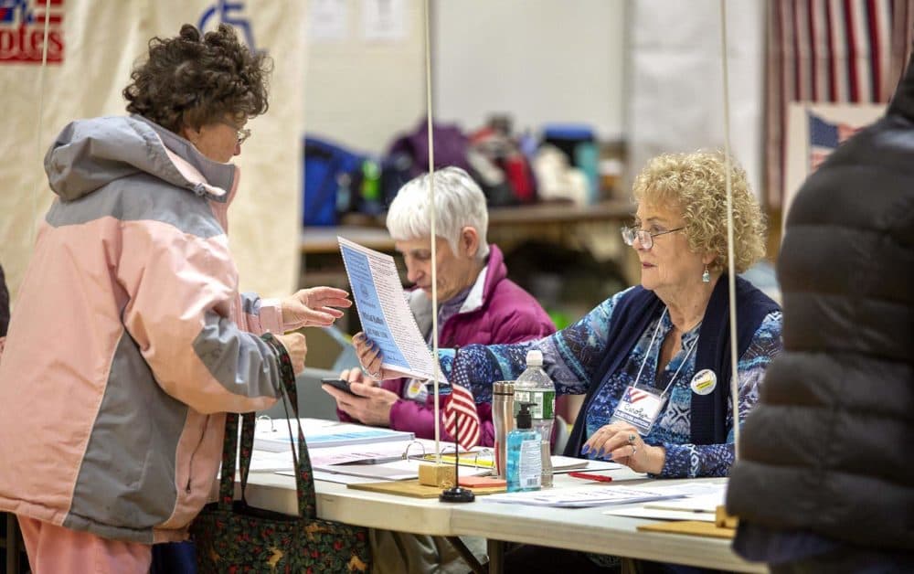 A voter collects her ballot at Broad Street Elementary School in Nashua, N.H. (Robin Lubbock/WBUR)