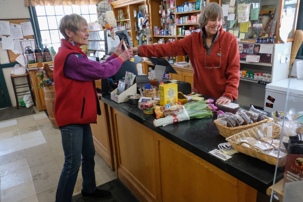 Toni Halla talks with a customer from behind the counter. (Jill Ryan/Here &amp; Now)