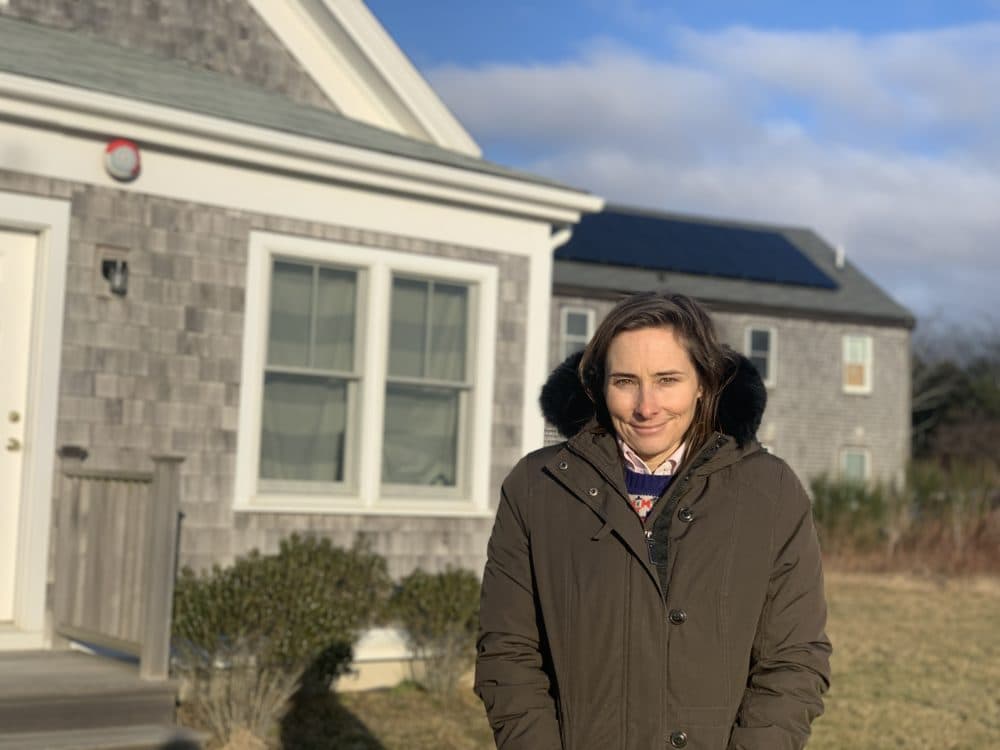 Anne Kuszpa heads the group Housing Nantucket. The house behind her was "recycled," moved from another lot instead of being demolished, and is now slated to become affordable housing. (Simon Rios/WBUR)