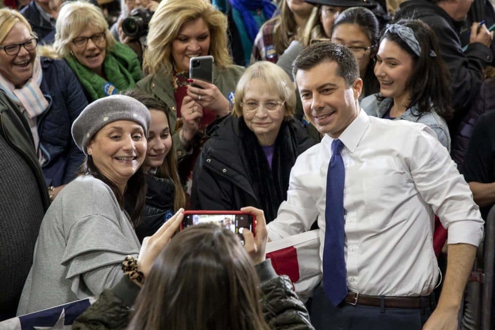 Pete Buttigeig takes a selfie with supporters at Elm Street Middle School in Nashua, NH. (Robin Lubbock/WBUR)