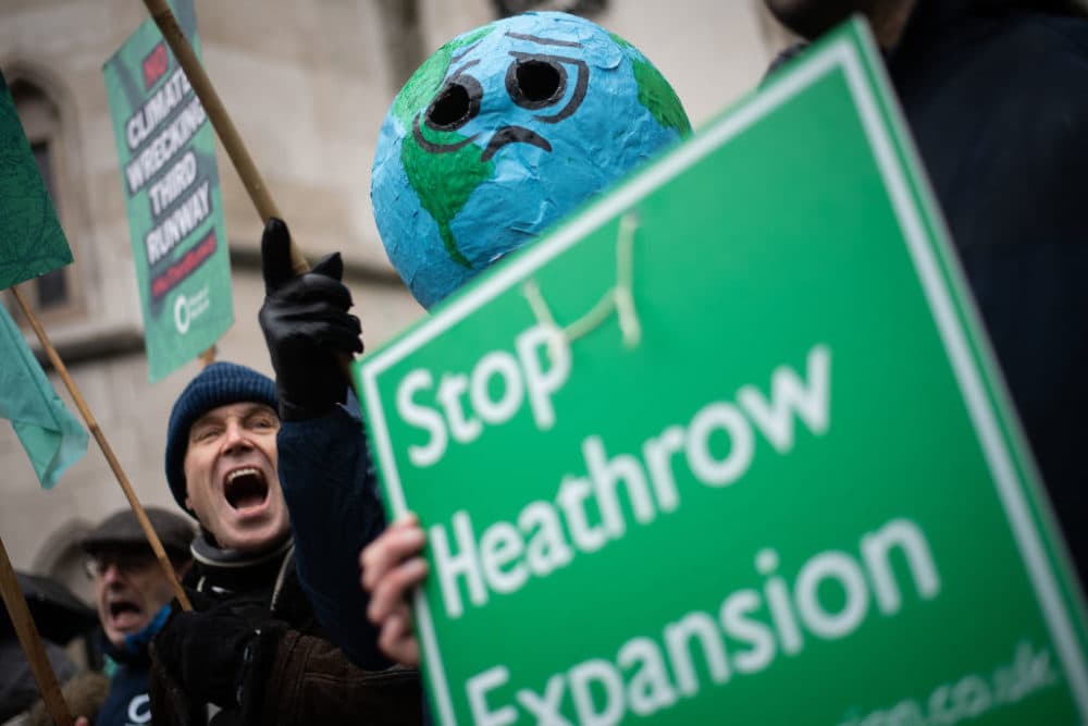 Environmental campaigners protest outside the Royal Courts of Justice ahead of the announcement of the ruling on the controversial third runway for Heathrow airport. (Leon Neal/Getty Images)