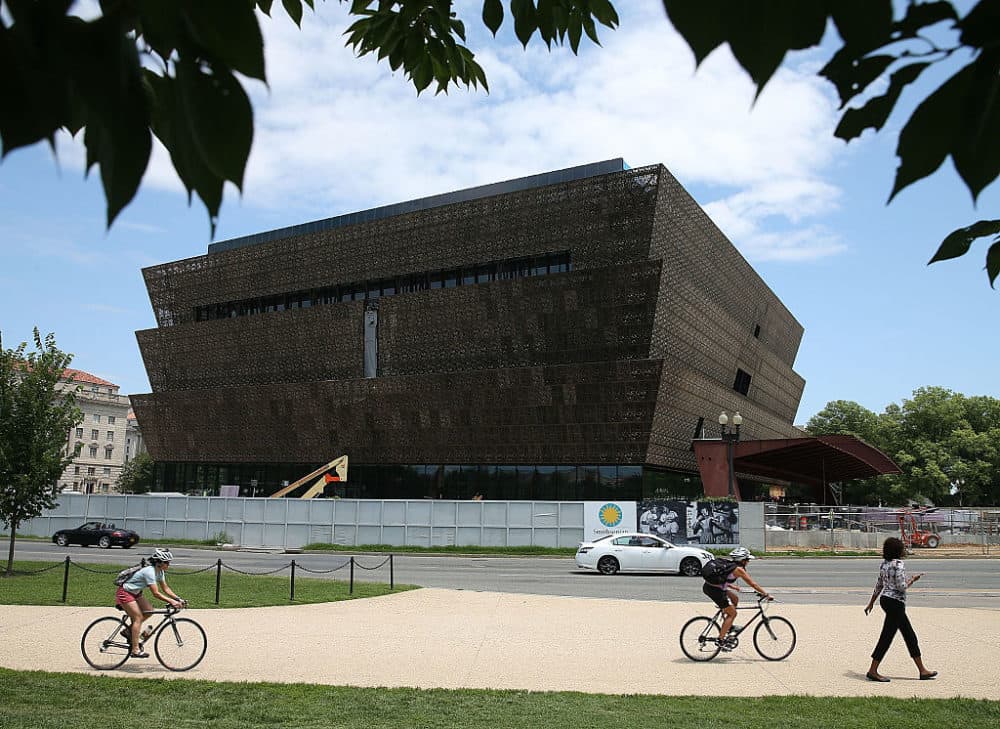 Tourists walk past the Smithsonian Museum of African American History and Culture in Washington, D.C. (Mark Wilson/Getty Images)