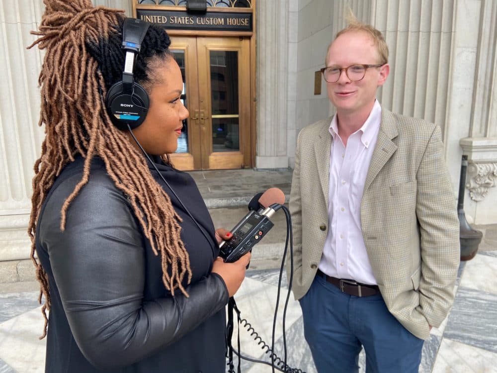 Host Tonya Mosley speaks to Jamie Lovegrove, political reporter for The Post and Courier, outside of the U.S. Custom's House in South Carolina. (Ciku Theuri/Here &amp; Now)