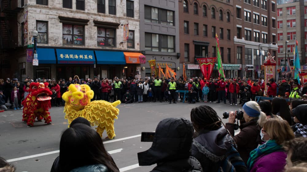At a parade Sunday in Boston's Chinatown celebrating the Lunar New Year, a few onlookers wore facemasks. (Adrian Ma/WBUR